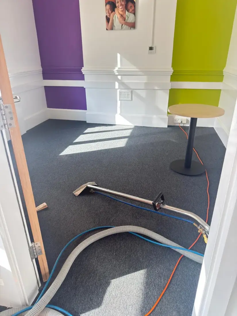 Carpet cleaning in progress in an office using hot water extraction